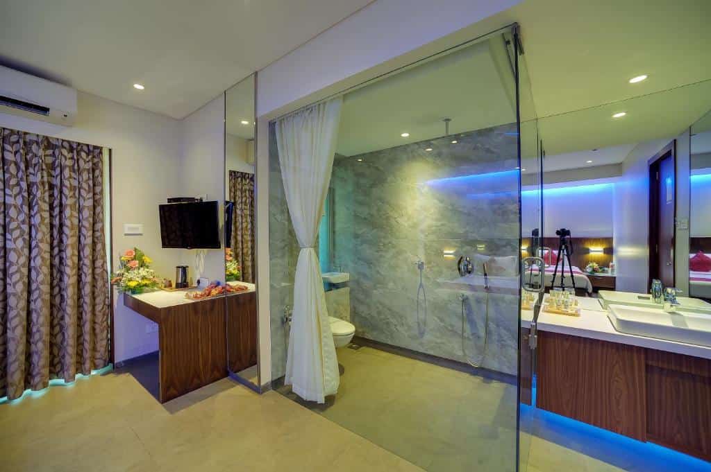 Bedroom with bathroom at Cygnett Inn Celestiial Goa